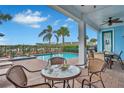 Relaxing patio area with small table and chairs near the pool at 3056 Parrot Head Pl, Kissimmee, FL 34747
