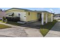 Mobile home with carport and mature shrubs at 115 Palm Dr, Eustis, FL 32726