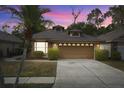 Attractive brick home at dusk with a two-car garage at 314 Macgregor Rd, Winter Springs, FL 32708