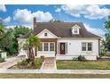 Front view of a two-story home with brick and stucco exterior, walkway, and landscaping at 1413 Dorothy Ave, Haines City, FL 33844