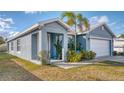 Side view of a single-story home with landscaping and attached two-car garage at 316 Bennett St, Auburndale, FL 33823