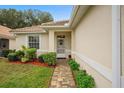 Front entrance with a brick walkway and nicely landscaped yard at 321 Fernhill Dr, Debary, FL 32713