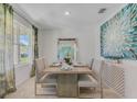 Dining room with large window and modern table with seating for six at 3541 Sandalwood Isle Way, Ocoee, FL 34761