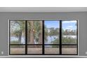 Stunning lake view from large windows in living room at 3966 Lake Mira Dr, Orlando, FL 32817