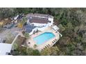 Aerial view of condo complex with pool and surrounding trees at 4344 Aqua Vista Dr # B, Orlando, FL 32839