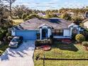 Single-story home with a large yard and driveway, viewed from above at 532 Maricopa Dr, Kissimmee, FL 34758