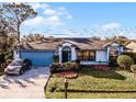 Single story home with blue garage door and neatly landscaped yard at 532 Maricopa Dr, Kissimmee, FL 34758