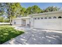 Close-up front view of a single-story home with an attached garage and driveway at 1469 Swan Pl, Kissimmee, FL 34759