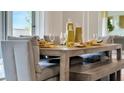 Dining area with gray upholstered chairs, wooden table, and decorative yellow vases at 2105 Pigeon Plum Dr, Haines City, FL 33844