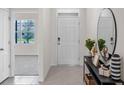 Inviting foyer with a console table, mirror, and views into other living spaces at 2109 Pigeon Plum Dr, Haines City, FL 33844