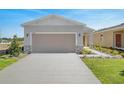 Modern single-story home with a two-car garage and a landscaped front yard at 4148 Lavender Ct, Lake Hamilton, FL 33851
