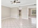 Spacious living room with tile flooring, a ceiling fan, and neutral-colored walls at 6030 Village Cir, Orlando, FL 32822