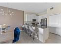 Modern kitchen with island, white cabinets, and stainless steel appliances at 781 Ocean Course Ave # 601, Davenport, FL 33896