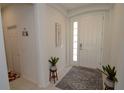 Bright and airy entryway with tile flooring and coat closet at 2393 Jernigan Loop, Kissimmee, FL 34746