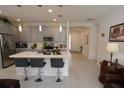 Modern kitchen with gray cabinets, white countertops, and island with seating at 2393 Jernigan Loop, Kissimmee, FL 34746