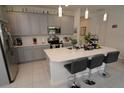 Modern kitchen with gray cabinets, white countertops and stainless steel appliances at 2393 Jernigan Loop, Kissimmee, FL 34746