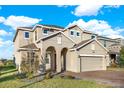 Two-story home with a welcoming front entrance and attached garage at 488 Sapphire Dr, Davenport, FL 33837