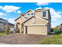 Inviting two-story home with a paved driveway and attached two-car garage at 488 Sapphire Dr, Davenport, FL 33837