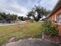 Landscaped front yard with a fire pit at 5165 Gwynne Ave, Orlando, FL 32810