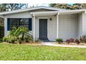 Charming curb appeal with manicured landscaping and a gray front door at 522 S Woodland St, Winter Garden, FL 34787