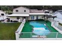 Relaxing kidney-shaped pool with a pergola and fenced backyard at 610 Alton Rd, Winter Springs, FL 32708