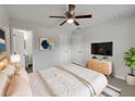 Spacious main bedroom with neutral walls, a large bed, and an ensuite bathroom at 7008 Watseka Ave, Orlando, FL 32818