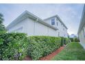 Side view of the house with green hedge at 8100 Fan Palm Way, Kissimmee, FL 34747