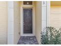 Dark brown front door entry with brick walkway and sidelights at 1415 Caring Ct, Maitland, FL 32751