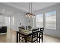 Dining area with four chairs and a modern light fixture at 1423 Amber Leaf Cir, Ocoee, FL 34761