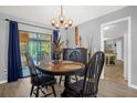 Quaint dining room with wooden table and chairs, and view to kitchen at 1608 Bomi Cir, Winter Park, FL 32792