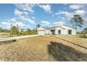 New construction home with gray siding and a concrete driveway at 1609 Pickerel Ct, Kissimmee, FL 34759