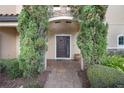 Inviting front entrance with a dark brown door and brick walkway at 2221 White Jasmine Ct, Apopka, FL 32712