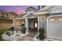 Inviting front entrance with a porch, walkway, and landscaping at 2377 Victoria Dr, Davenport, FL 33837