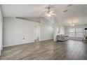 Spacious living room with wood-look tile flooring and access to the backyard at 264 Chicago W Ave, Haines City, FL 33844