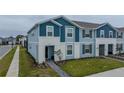 Blue townhome with walkway and landscaping at 4250 Lana Ave, Davenport, FL 33897