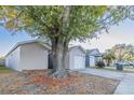 House exterior showcasing a large tree and driveway at 5436 Wood Crossing St, Orlando, FL 32811