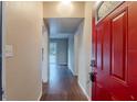 Bright entryway with red door and wood floors at 5815 Harrington Dr, Orlando, FL 32808