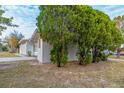 Side view of a tan house with lush green landscaping at 5815 Harrington Dr, Orlando, FL 32808