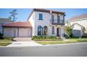 Two-story house with red tile roof, two-car garage, and landscaping at 7493 Estuary Lake Loop, Kissimmee, FL 34747