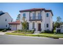 Two-story house with red tile roof, two-car garage, and landscaping at 7493 Estuary Lake Loop, Kissimmee, FL 34747