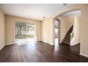 Spacious living room with dark hardwood floors and access to backyard at 11520 Robbyes Dr, Orlando, FL 32817