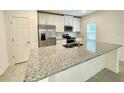 Modern kitchen with stainless steel appliances and granite countertops at 1839 Osprey Perch Rd, Davenport, FL 33837