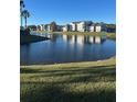 Community lake view with condo buildings reflecting in the water at 2208 Antigua Pl # 924, Kissimmee, FL 34741