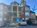 Condo building exterior with parking lot and landscaping at 2208 Antigua Pl # 924, Kissimmee, FL 34741