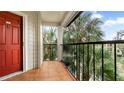 Condo balcony with tiled flooring and palm trees at 3032 Parkway Blvd # 302, Kissimmee, FL 34747