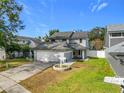 Two-story house with gray siding, attached garage, and landscaped yard at 3692 Okeechobee Cir, Casselberry, FL 32707