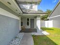 Front entrance with gray siding, a walkway, and a small bench at 3692 Okeechobee Cir, Casselberry, FL 32707