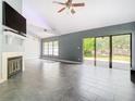 Spacious living room with fireplace, tile floors, and sliding glass doors at 3692 Okeechobee Cir, Casselberry, FL 32707