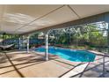 Relaxing pool area with covered patio and hammock at 4012 Moorings Ln # 1, Orlando, FL 32810