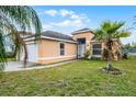 House exterior with a screened porch and palm trees at 4908 Monarch Ln, Kissimmee, FL 34746